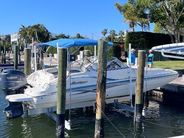 Slide: The Image of 2007 Hurricane 237 Sundeck Yamaha F250 boat docked with blue canopy. - 0