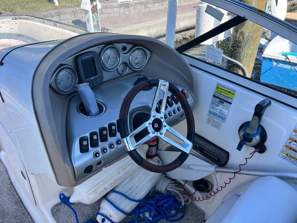 Slide: The Image of 2007 Hurricane 237 Sundeck Yamaha F250 boat dashboard with steering wheel and control panel. - 10