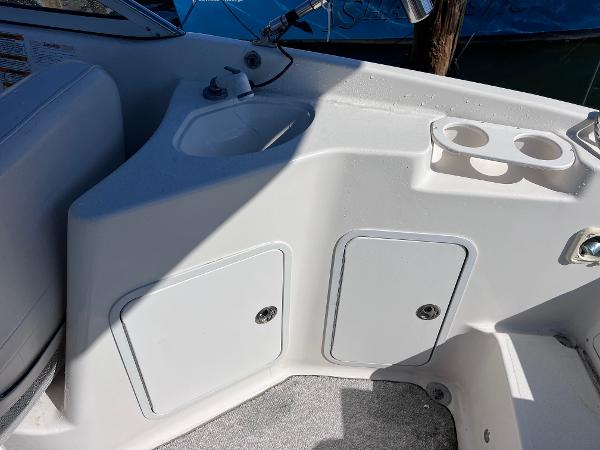 Slide: The Image of 2007 Hurricane 237 Sundeck Yamaha F250 boat interior with storage compartments and cup holders. - 11