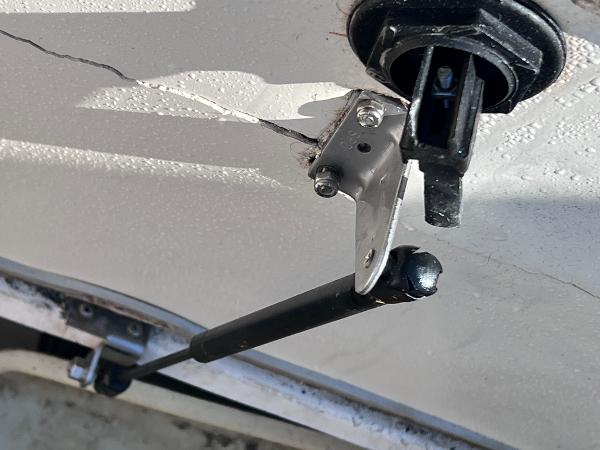 Slide: The Image of Close-up of a 2007 Hurricane 237 Sundeck Yamaha F250 boat's gas strut and mounting bracket. - 18