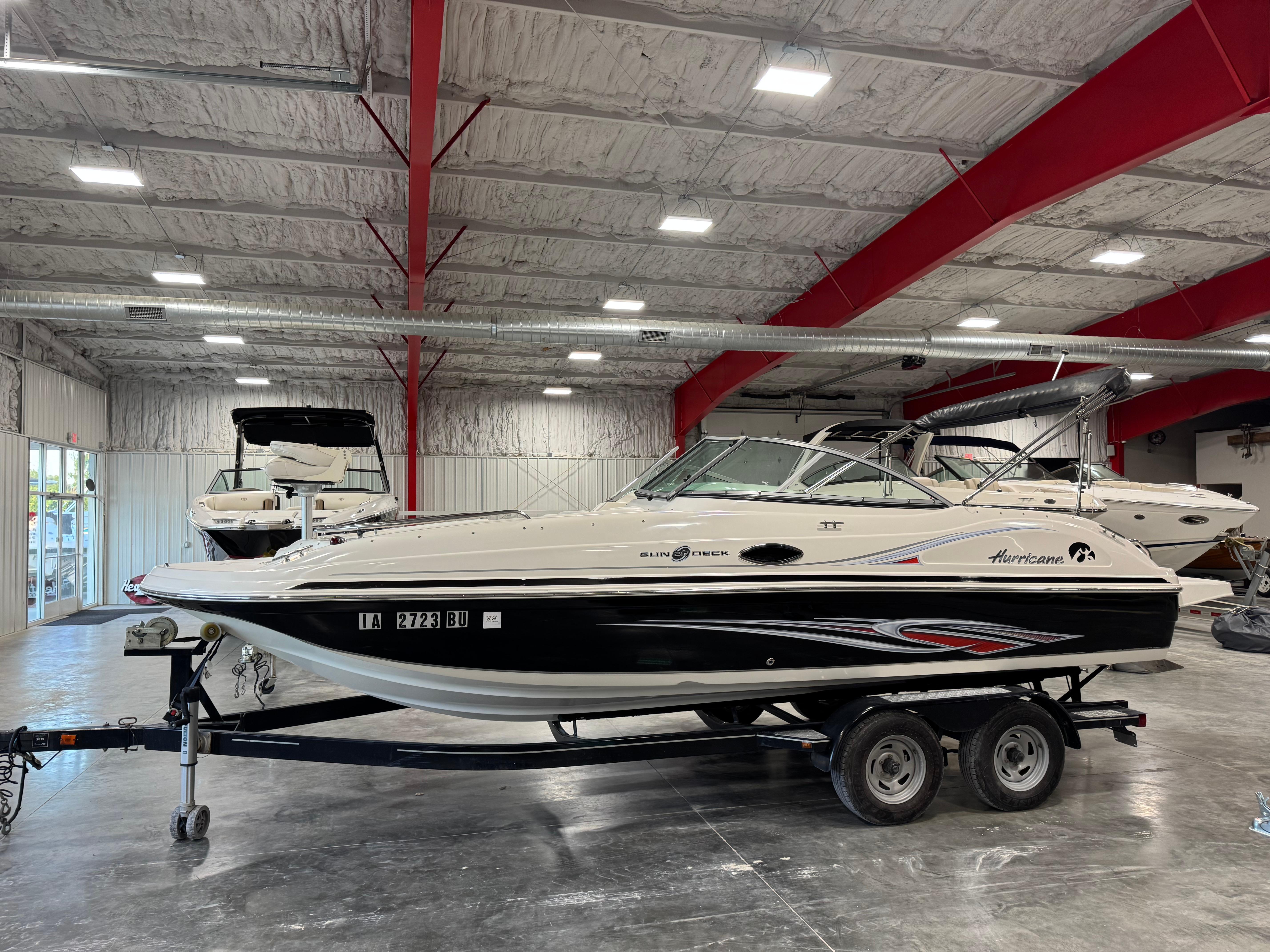 Slide: The Image of 2011 Hurricane SD217 boat on trailer in indoor showroom. - 1