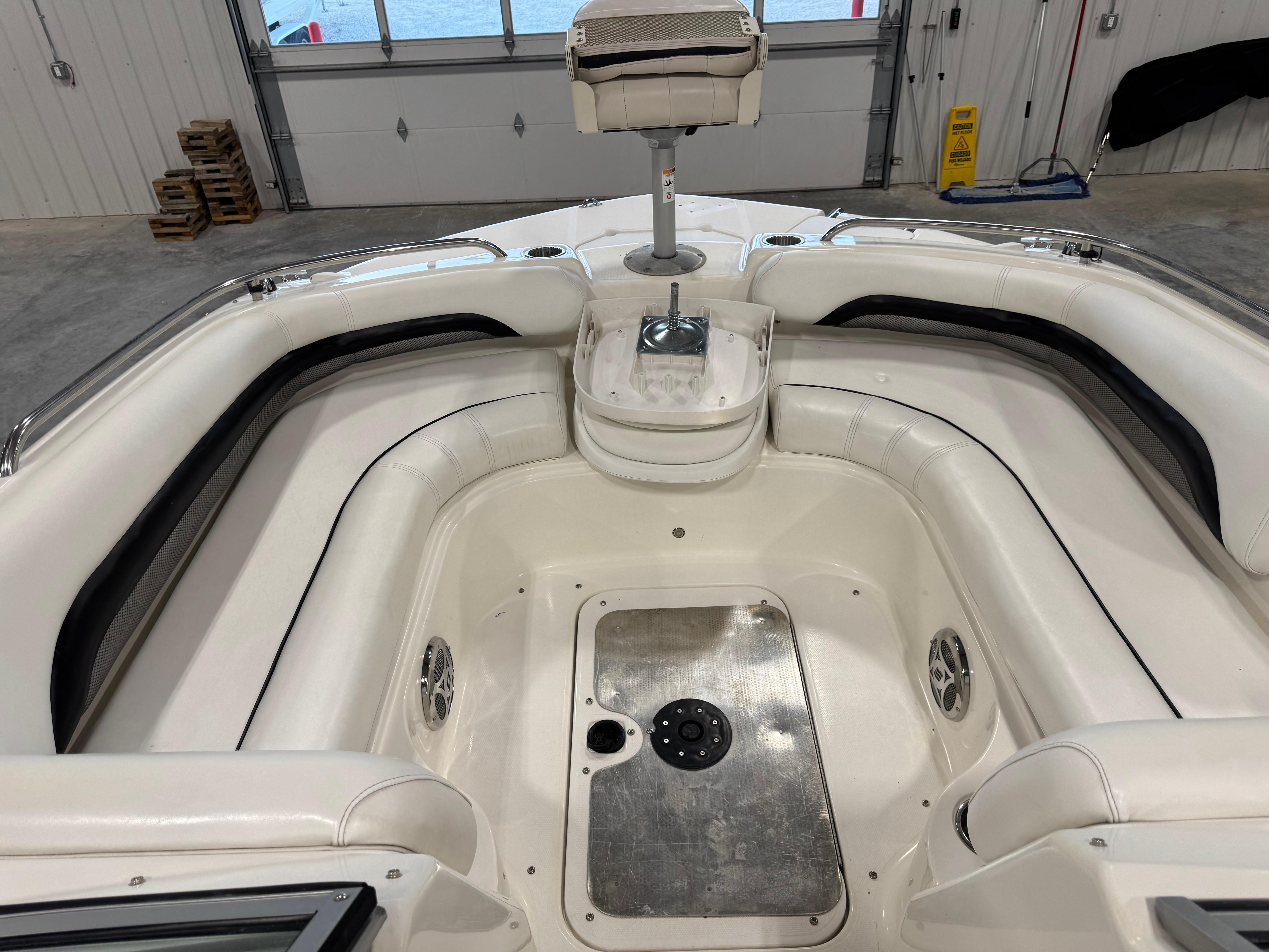 Slide: The Image of Interior of a 2011 Hurricane SD217 boat with white seating and metal flooring. - 3