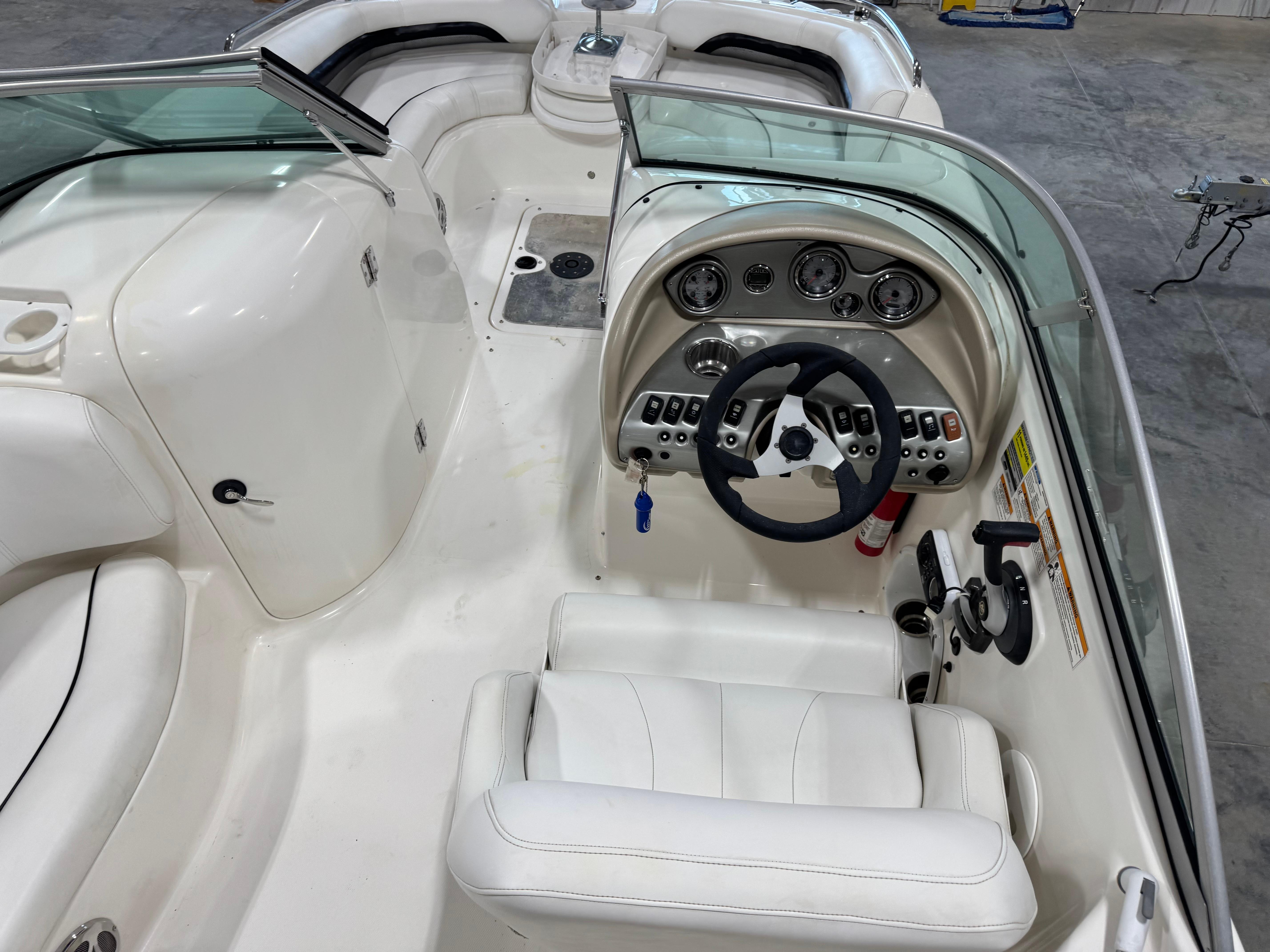 Slide: The Image of Interior of a 2011 Hurricane SD217 boat with white seating and control panel. - 4