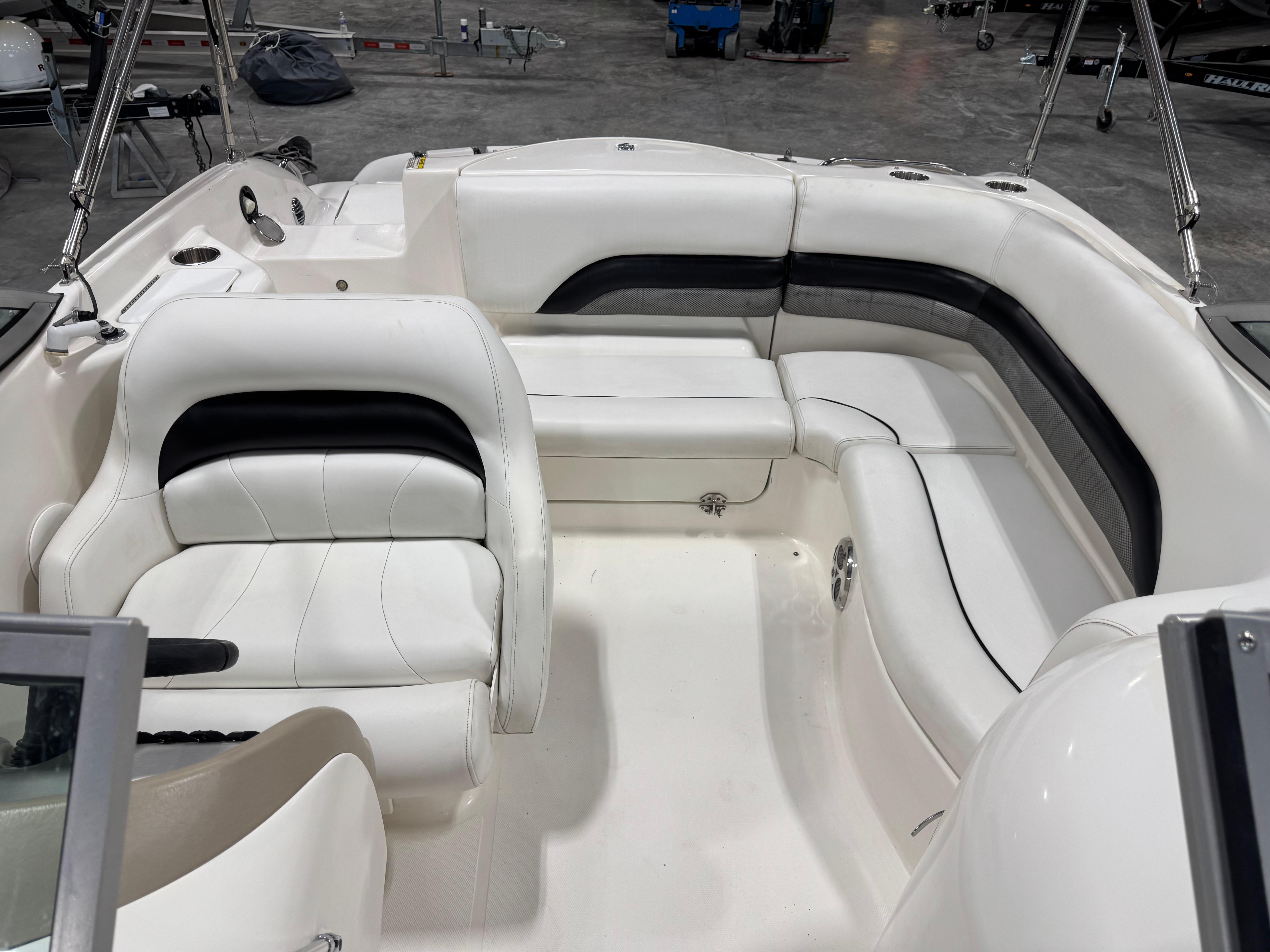 Slide: The Image of 2011 Hurricane SD217 boat interior with white and black seating in a showroom. - 6