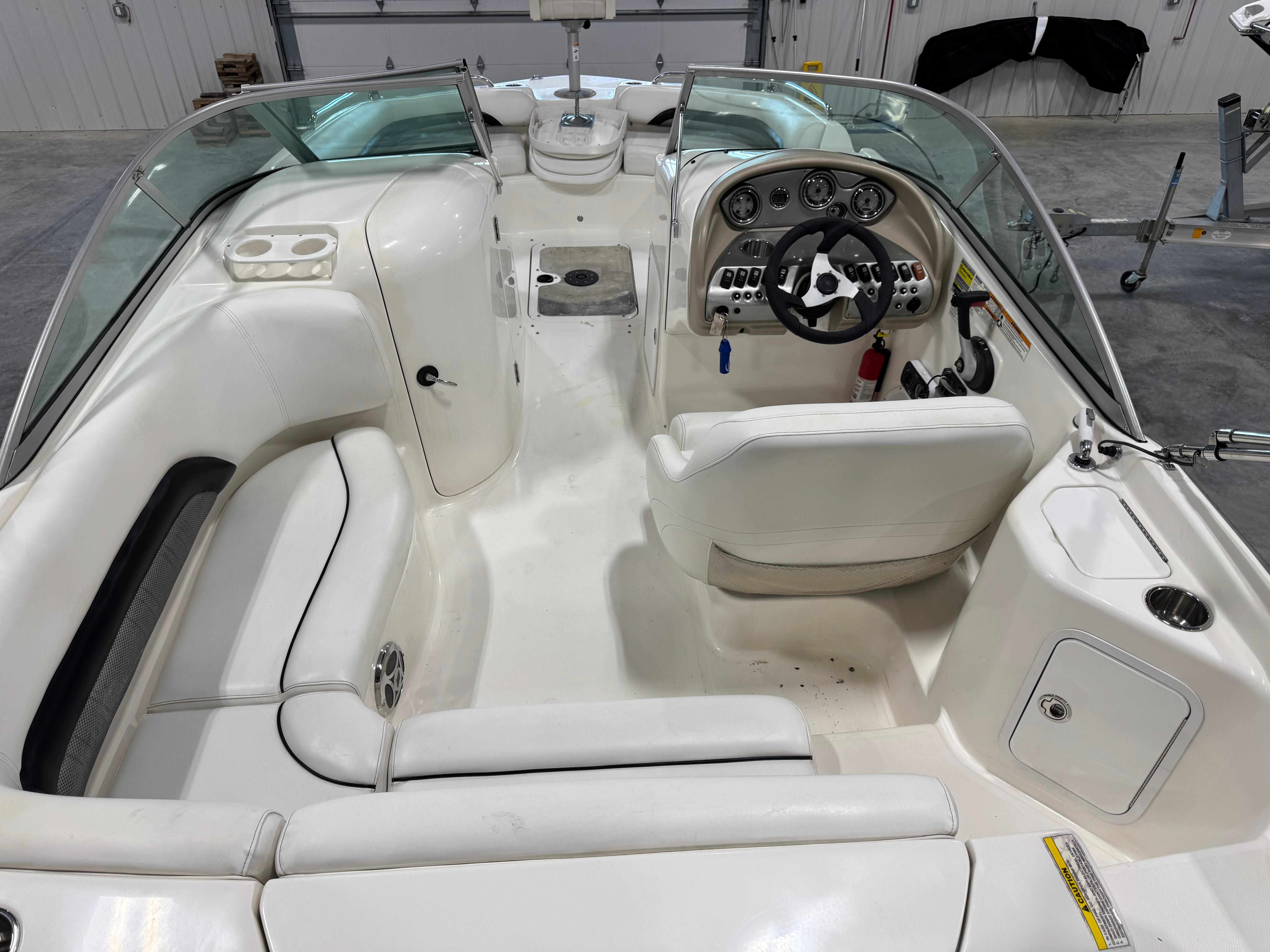 Slide: The Image of 2011 Hurricane SD217 boat interior with white seating and steering console. - 7