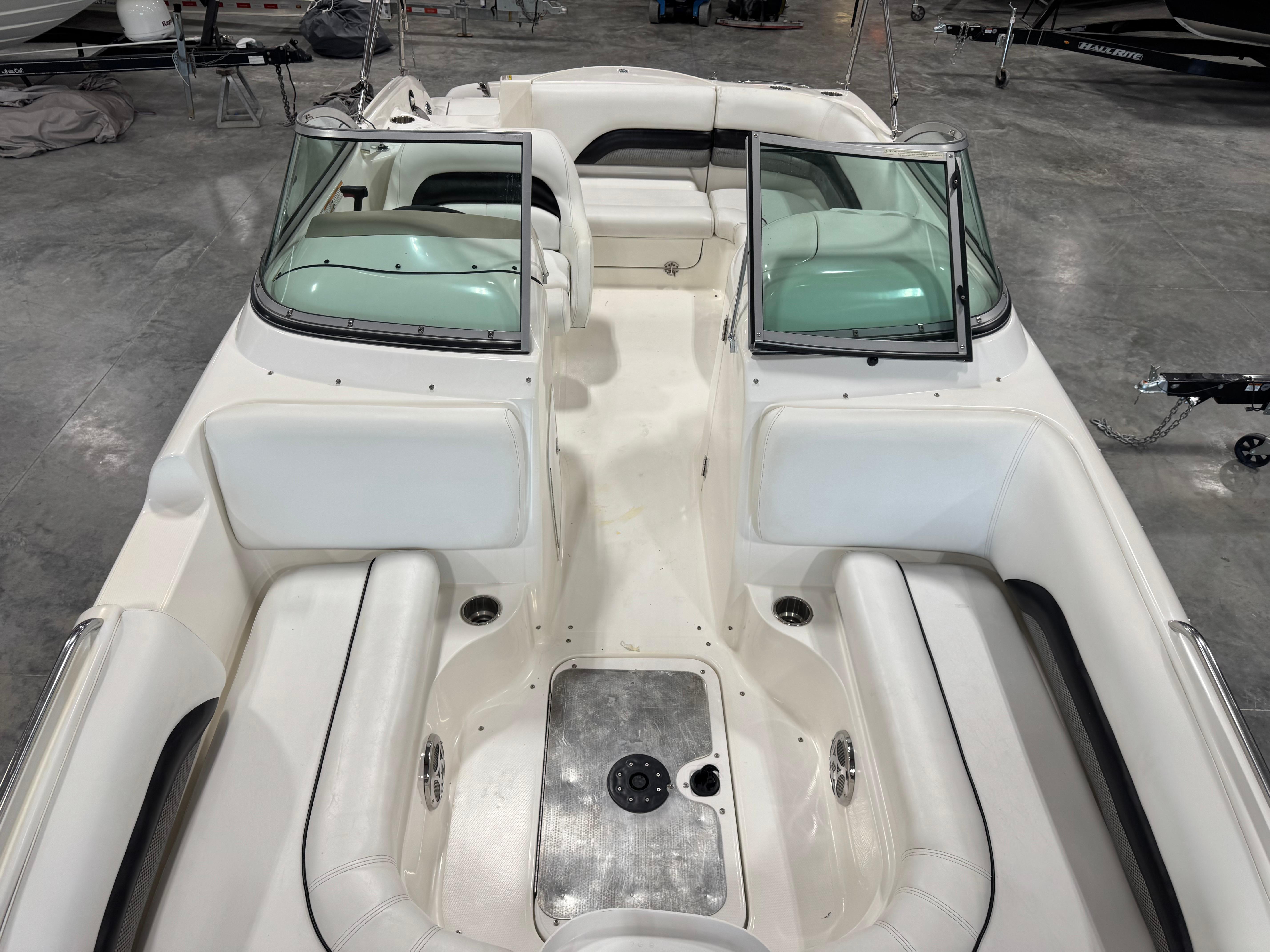 Slide: The Image of 2011 Hurricane SD217 boat interior with white seating and open windshield in a showroom. - 7