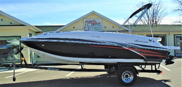 Slide: The Image of 2019 Hurricane SS188 boat on trailer outside a building, featuring sleek black and white design. - 1