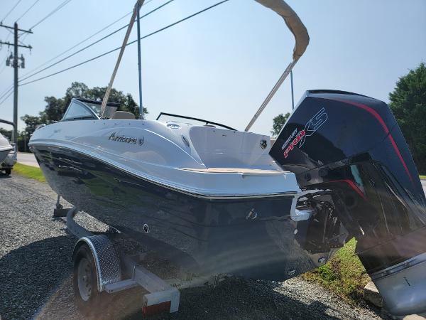 Slide: The Image of 2024 Hurricane SunDeck 217 OB boat on trailer with outboard motor. - 3