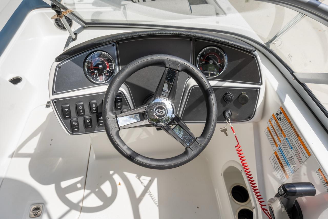 Slide: The Image of 2025 Hurricane SunDeck 217 OB boat dashboard with steering wheel and control panel. - 12