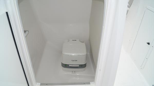 Slide: The Image of 2023 Hurricane SunDeck 235 OB boat interior with portable toilet. - 14