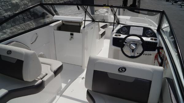 Slide: The Image of 2023 Hurricane SunDeck 235 OB boat interior with steering wheel and seating. - 16