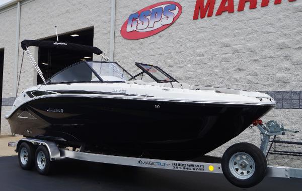 Slide: The Image of 2023 Hurricane SunDeck 235 OB boat on a trailer outside GSPS Marine. - 2