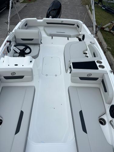 Slide: The Image of 2024 Hurricane SunDeck Sport 185 OB boat interior with seating and steering wheel. - 2