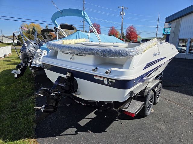 Slide: The Image of 2026 Hurricane SunDeck Sport 201 IO boat on trailer, outdoor display, sunny day. - 2