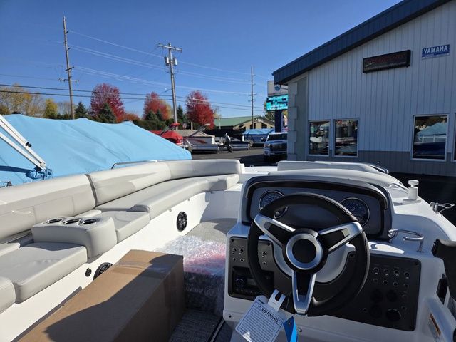 Slide: The Image of 2026 Hurricane SunDeck Sport 201 IO boat interior with steering wheel and seating, displayed outdoors. - 5
