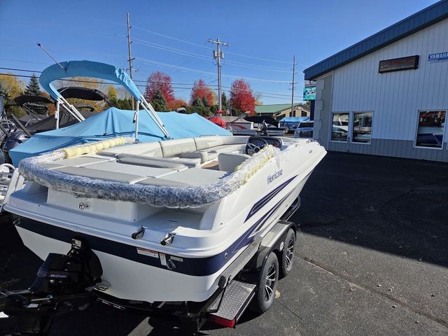 Slide: The Image of 2026 Hurricane SunDeck Sport 201 IO boat on trailer, parked outside dealership. - 8