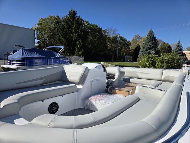 Slide: The Image of 2026 Hurricane SunDeck Sport 201 IO boat with spacious seating, docked outdoors. - 9