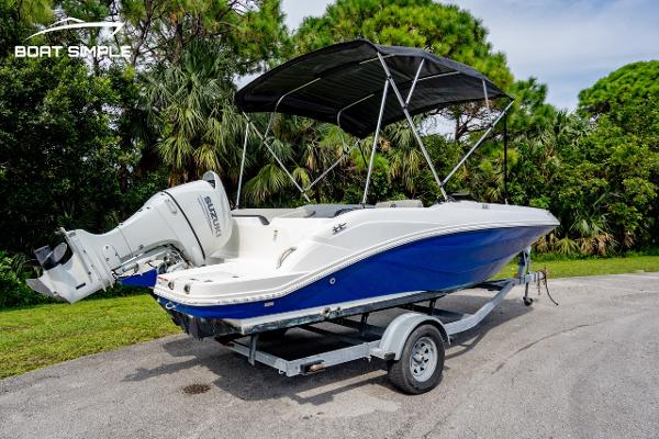 Slide: The Image of 2021 Hurricane SunDeck Sport 205 OB boat on trailer, parked outdoors. - 3