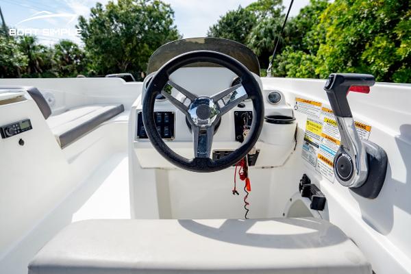 Slide: The Image of 2021 Hurricane SunDeck Sport 205 OB boat cockpit with steering wheel and controls. - 5