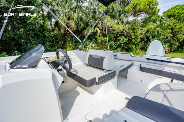 Slide: The Image of 2021 Hurricane SunDeck Sport 205 OB boat interior with seating and steering wheel. - 6