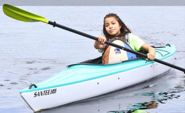 Slide: The Image of Young girl kayaking in a 2023 Hurricane Kayaks Santee 126 Sport on calm water. - 4