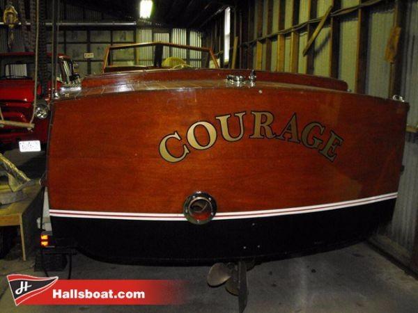 Slide: The Image of 1950 Hutchinson Utility boat named Courage in a storage shed. - 2