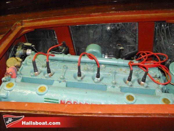 Slide: The Image of 1950 Hutchinson Utility boat engine with red wires and teal components. - 3