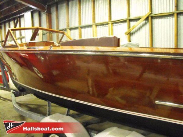 Slide: The Image of 1950 Hutchinson Utility wooden boat in a storage facility. - 5