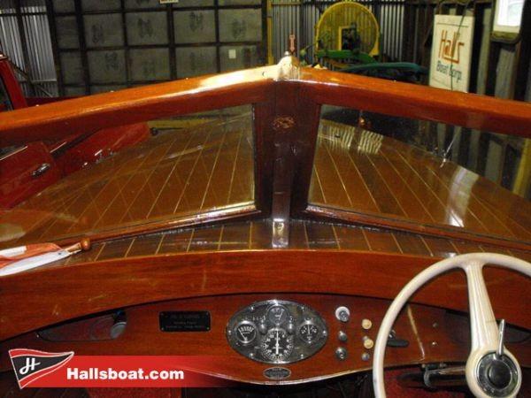 Slide: The Image of 1950 Hutchinson Utility boat dashboard with wooden finish and vintage gauges. - 6
