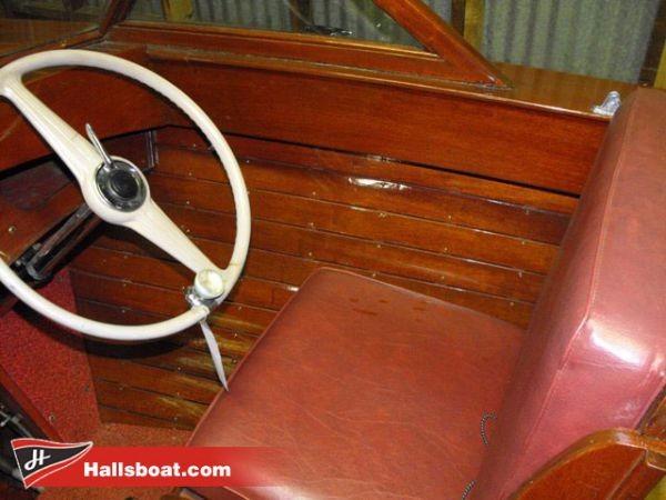 Slide: The Image of 1950 Hutchinson Utility boat interior with wooden paneling and red leather seat. - 7