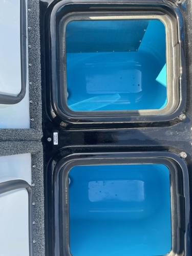 Slide: The Image of 2024 iKon LX21 boat livewell compartments with blue interior. - 11