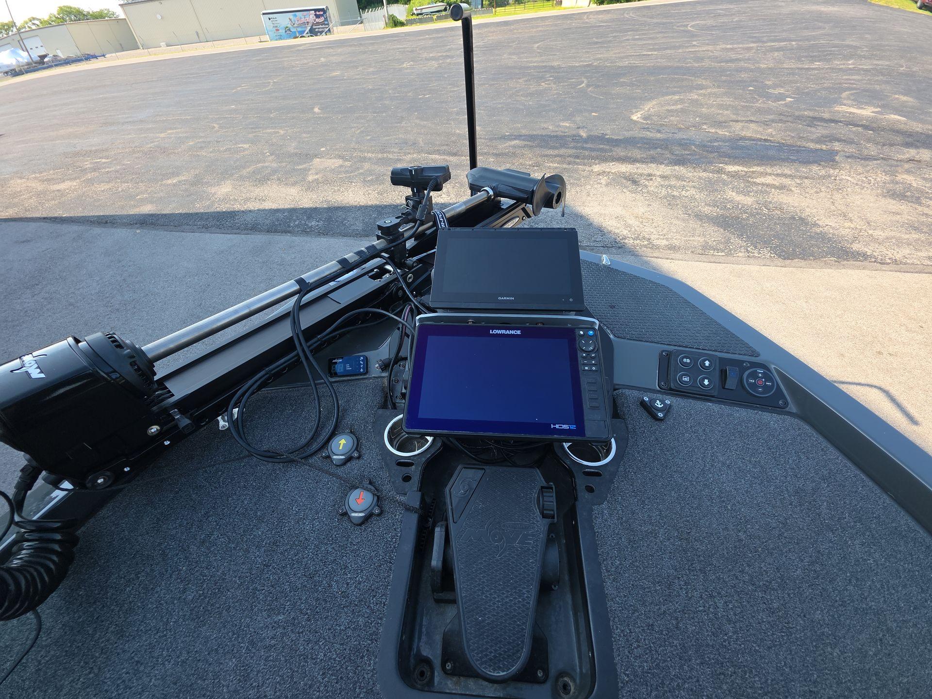 Slide: The Image of Fishing boat dashboard with electronics, featuring iKon LX21 model, 2025. - 13