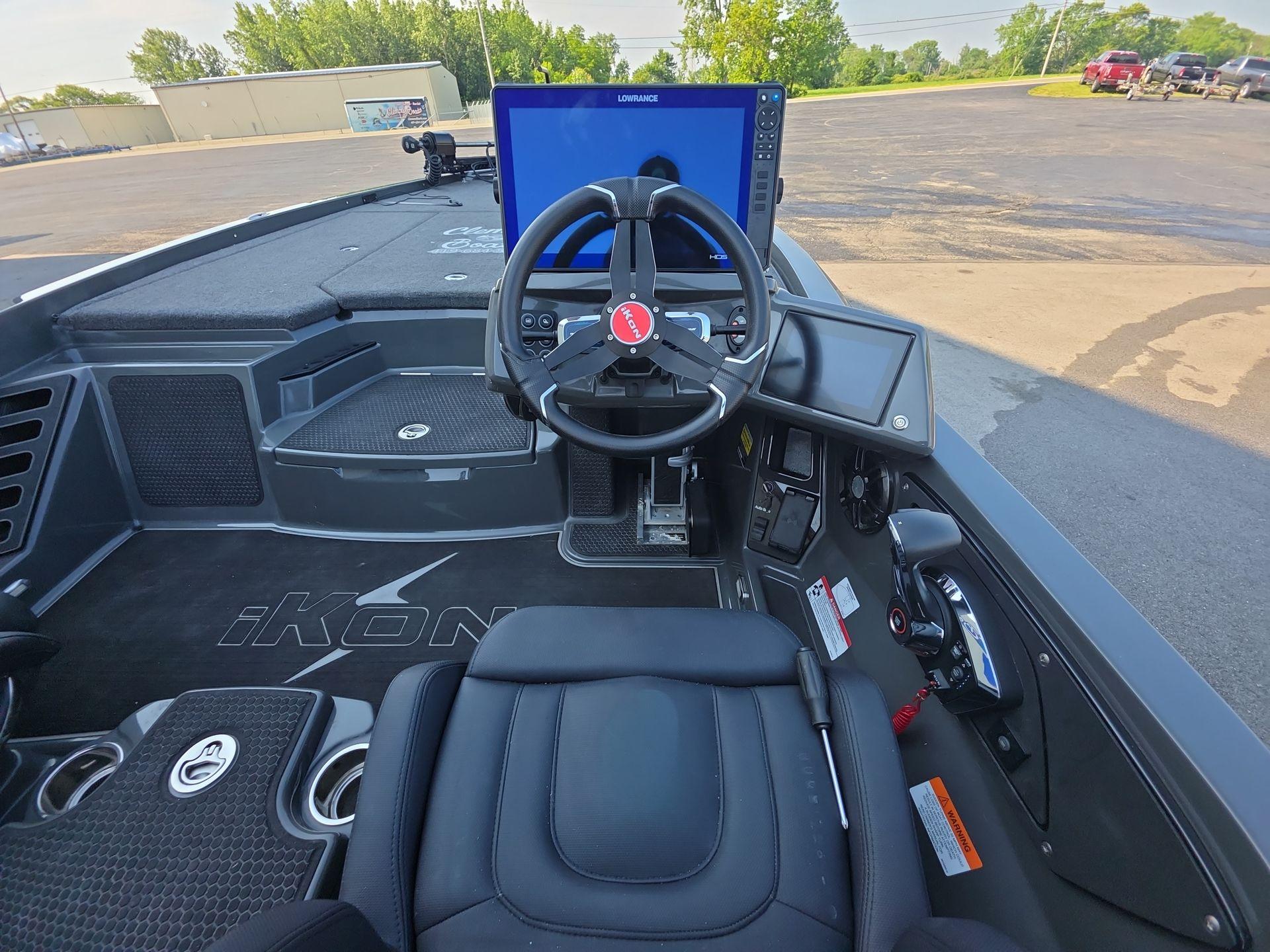 Slide: The Image of Interior of 2025 iKon LX21 boat with steering wheel and navigation display. - 14