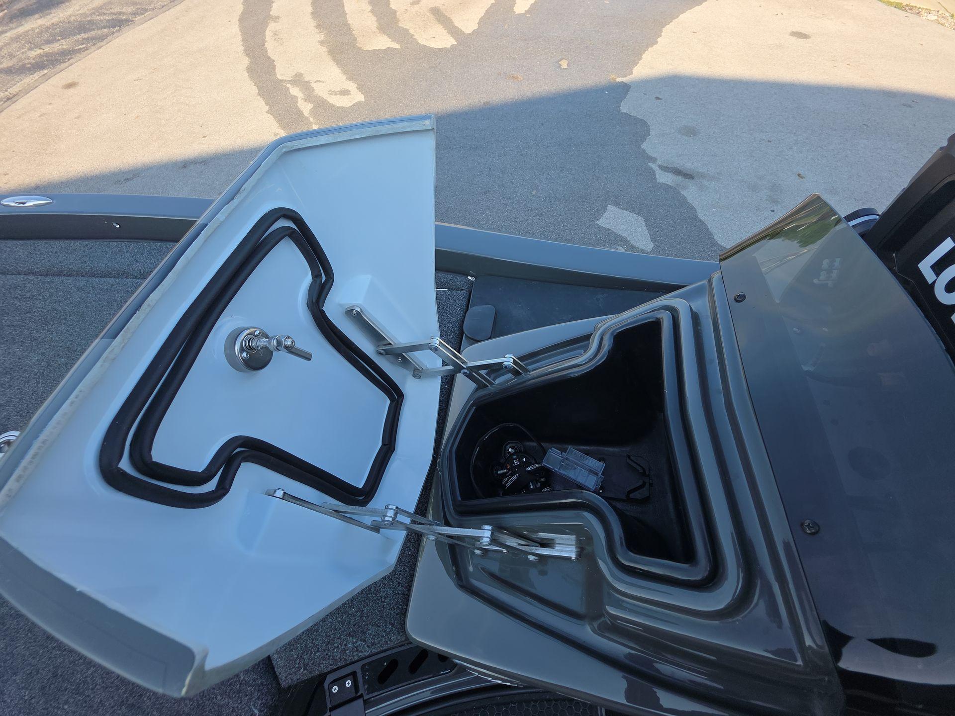 Slide: The Image of Open storage compartment on iKon LX21 boat, 2025 model, showing interior details. - 16