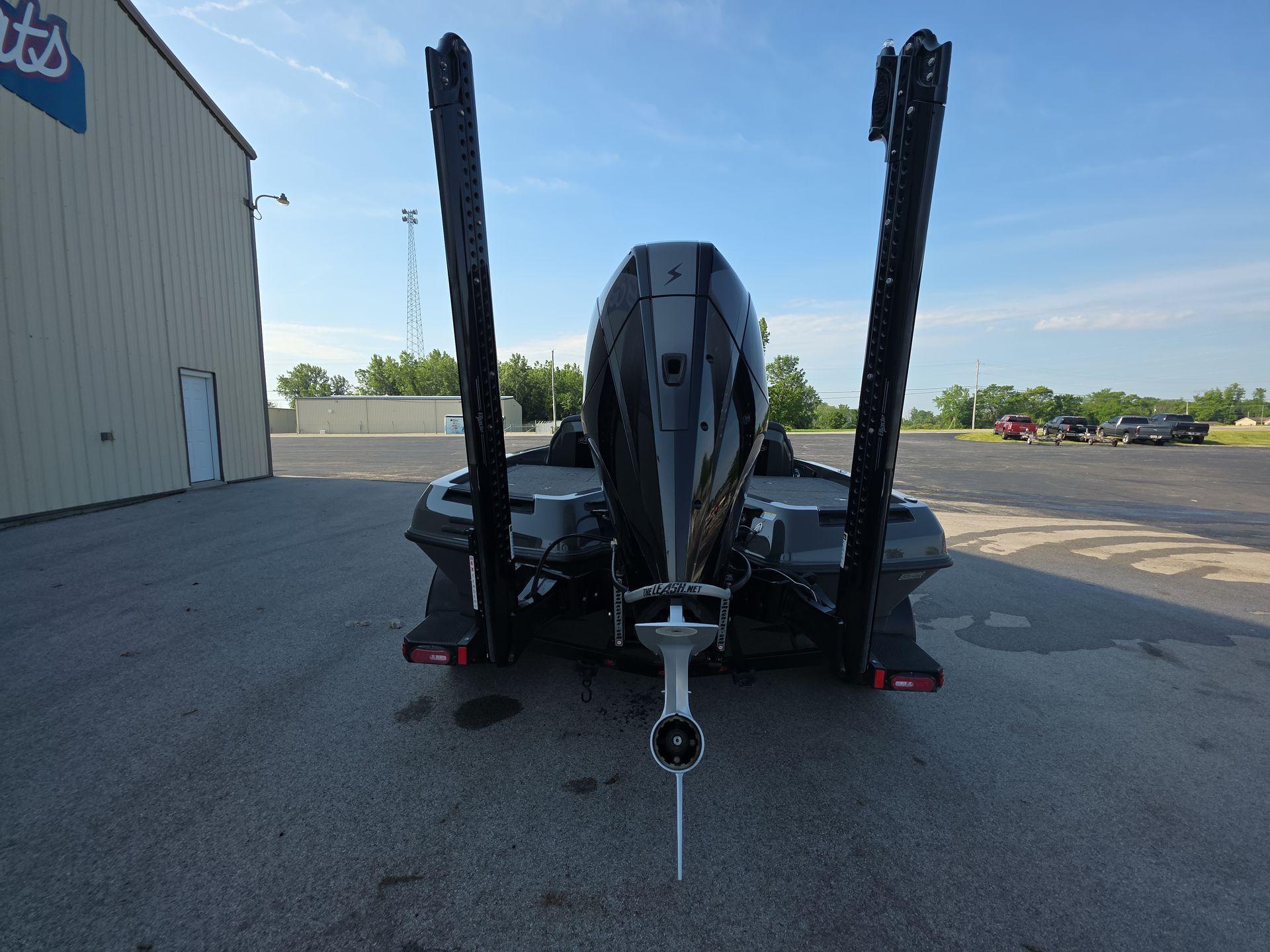 Slide: The Image of Rear view of 2025 iKon LX21 boat with dual power poles in a parking lot. - 5