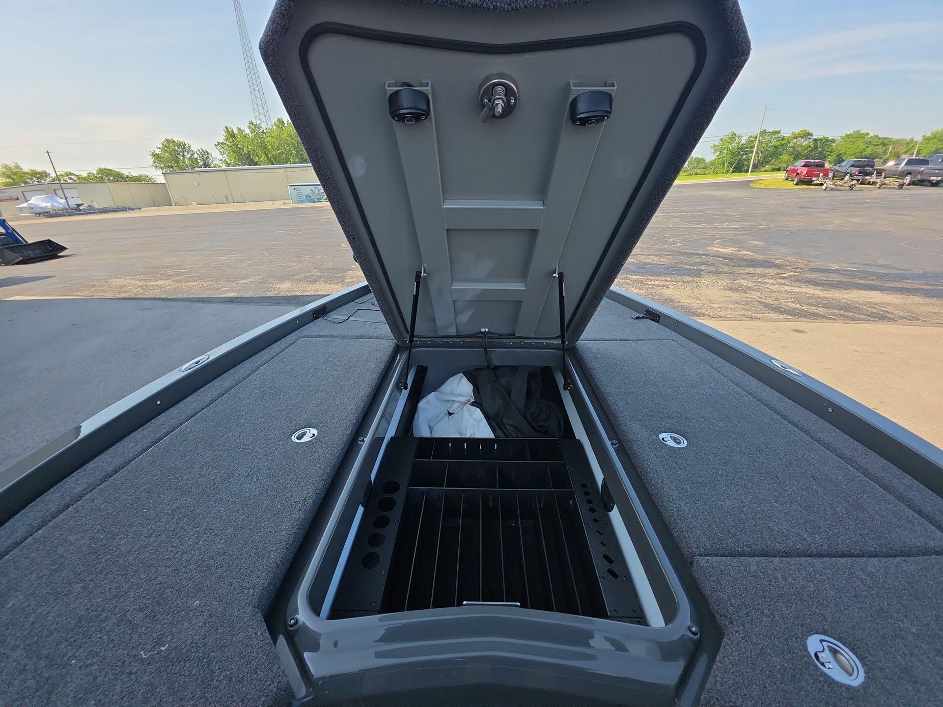 Slide: The Image of Open storage compartment on 2025 iKon LX21 boat, showcasing interior space and design. - 8
