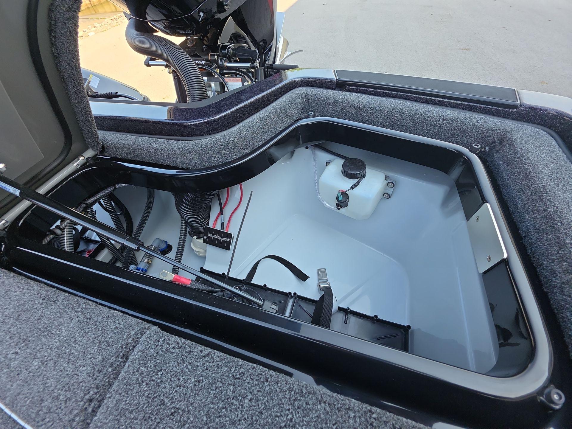Slide: The Image of Open storage compartment in 2026 iKon LX21 boat, showcasing interior details and wiring. - 10