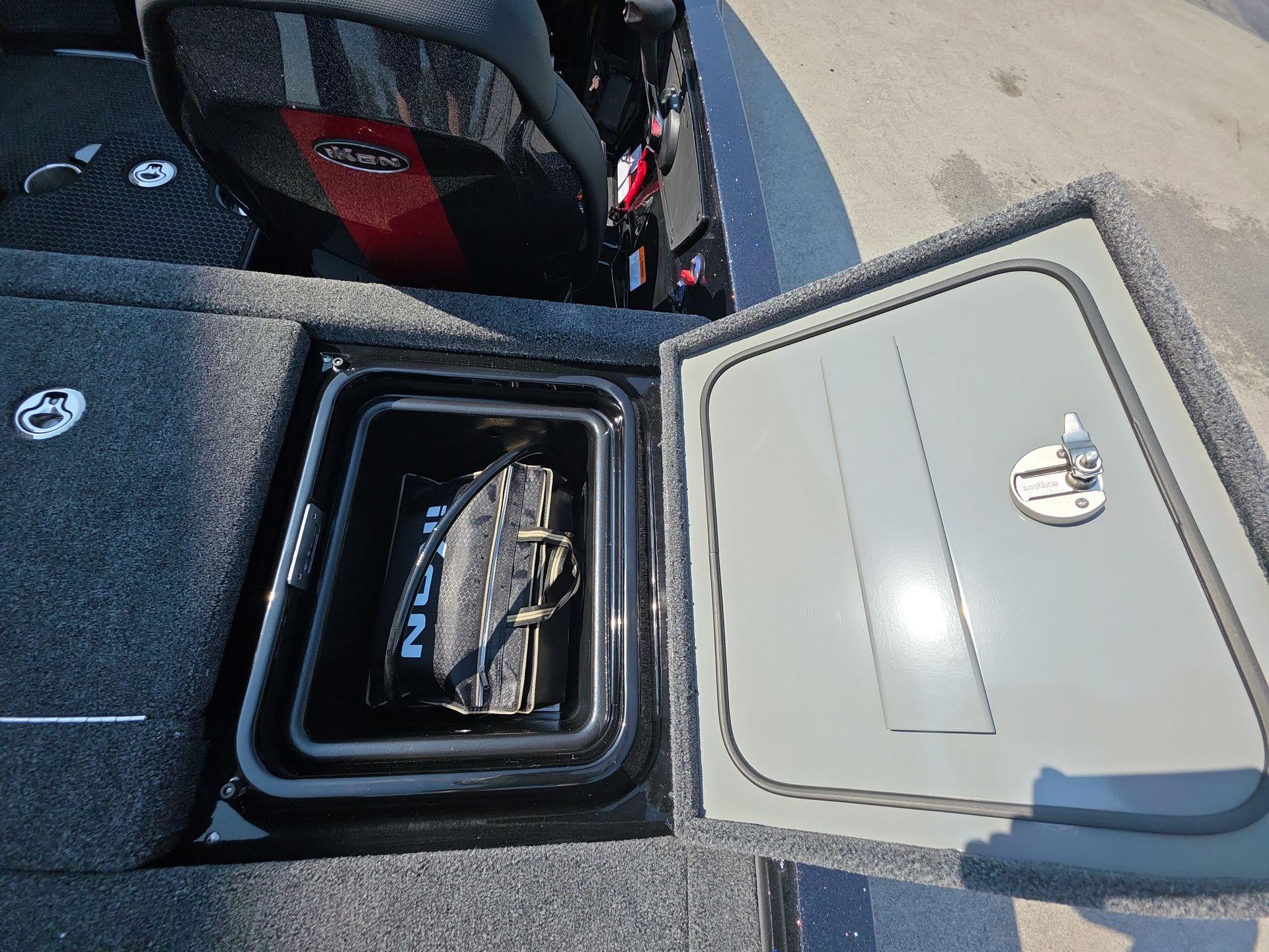 Slide: The Image of Open storage compartment in 2026 iKon LX21 boat with bag inside. - 12