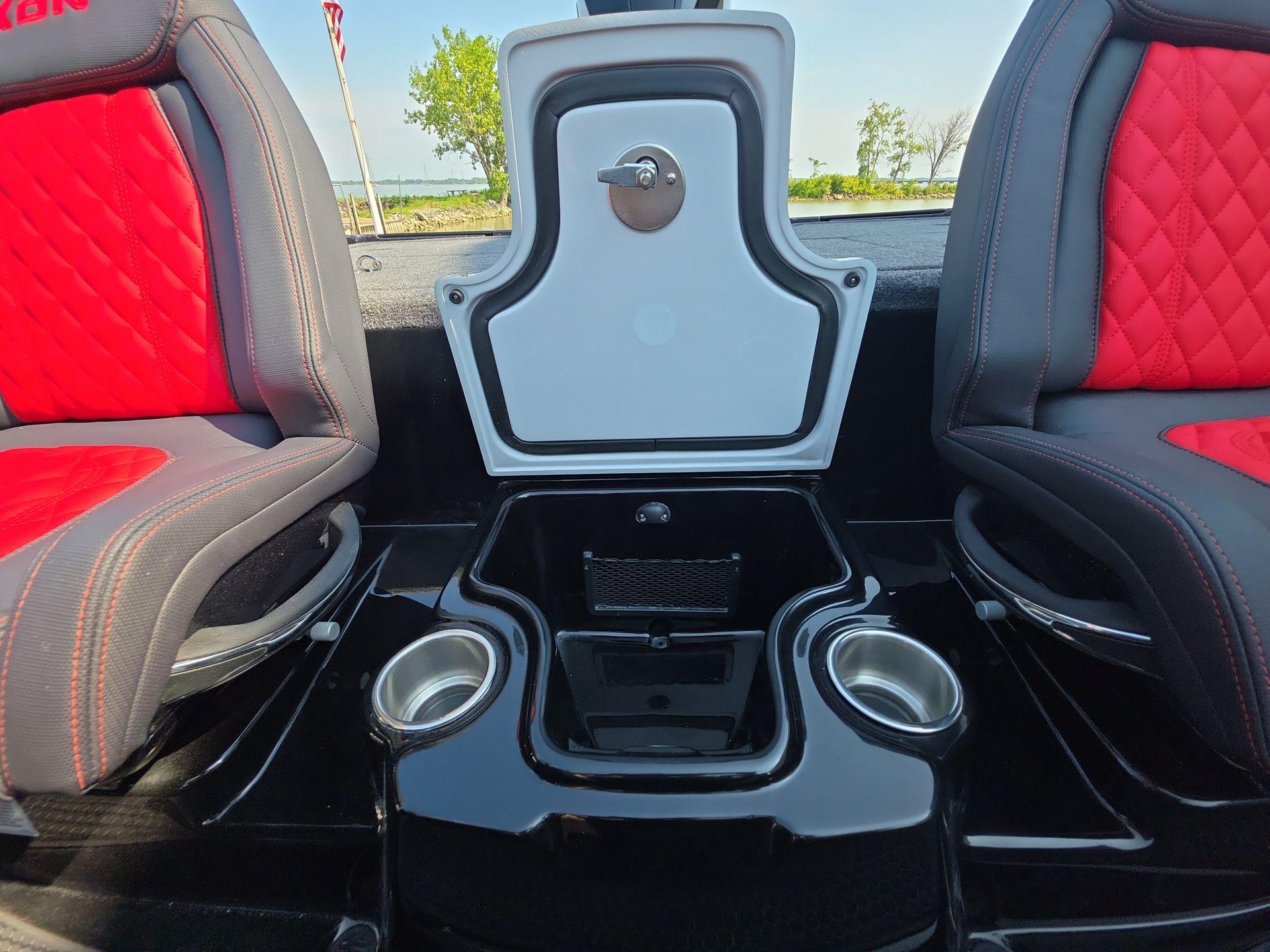 Slide: The Image of Interior of 2026 iKon LX21 boat with red and black seats, cup holders, and storage compartment. - 15