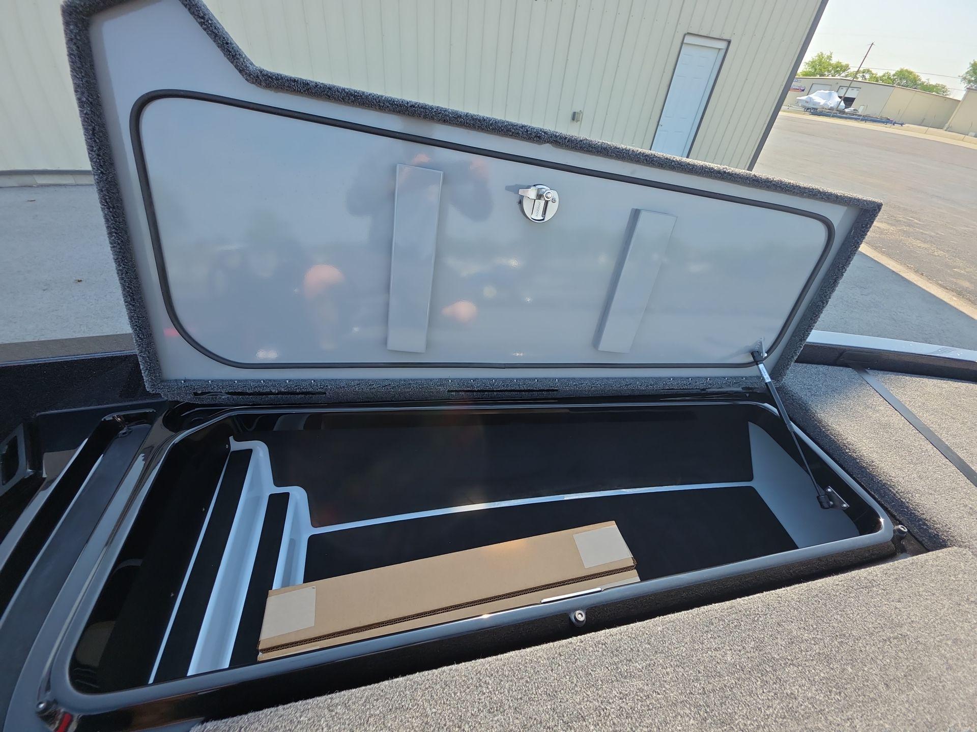 Slide: The Image of Open storage compartment of 2026 iKon LX21 boat, showcasing interior space and design. - 20