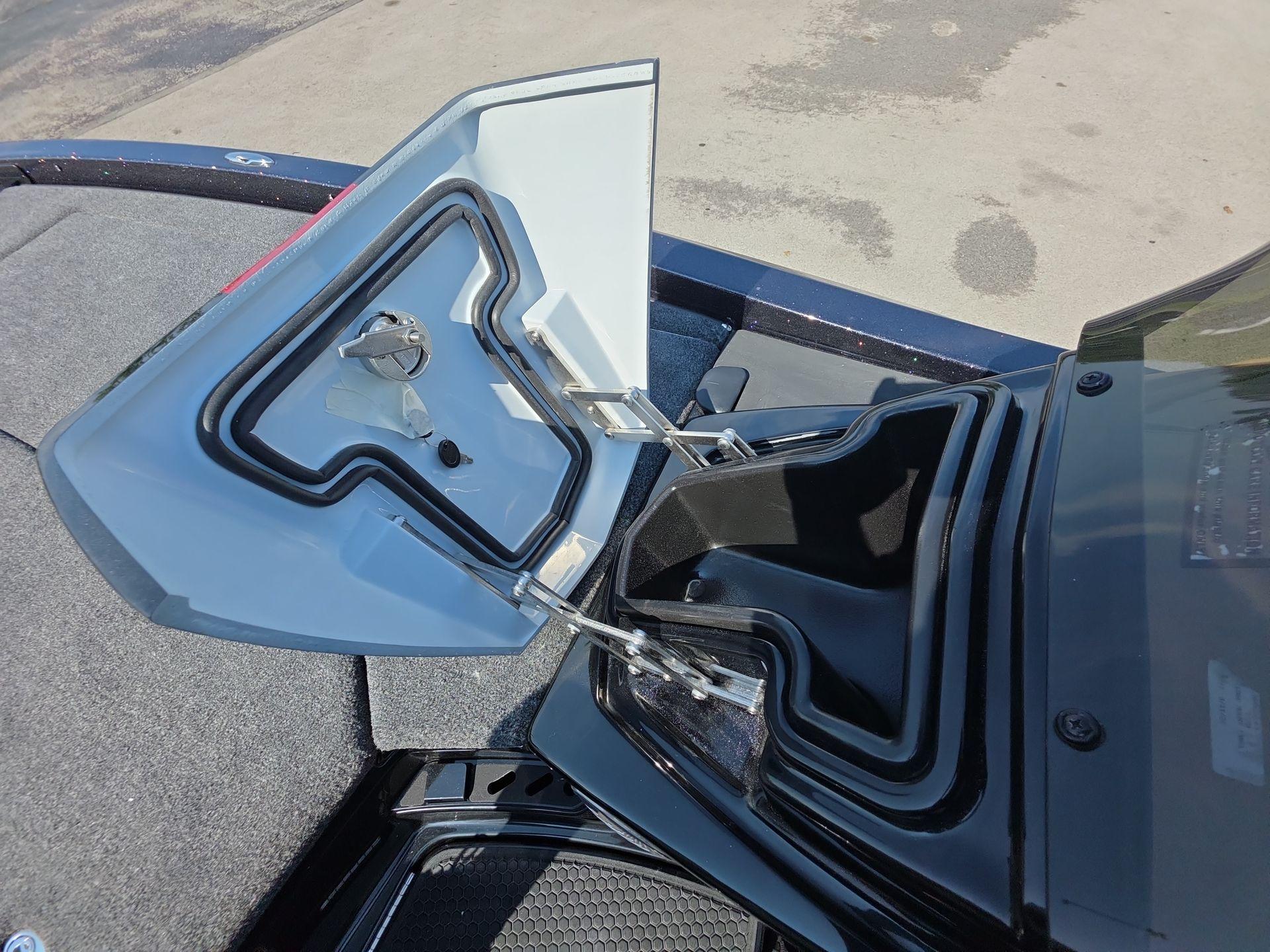 Slide: The Image of Open storage compartment of iKon LX21 boat, showcasing interior design and latch mechanism. - 8