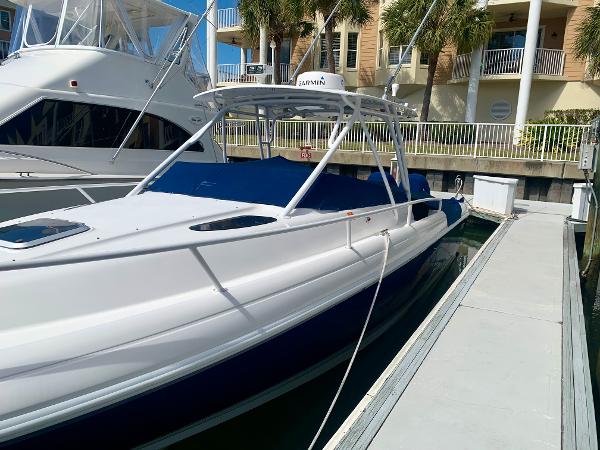 Slide: The Image of 2002 Intrepid 348 Walkaround boat docked at marina. - 2