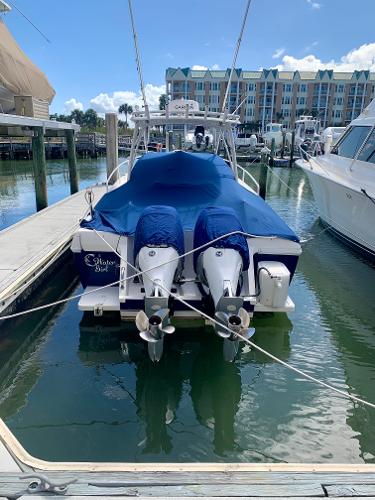 Slide: The Image of 2002 Intrepid 348 Walkaround boat docked with blue covers. - 6