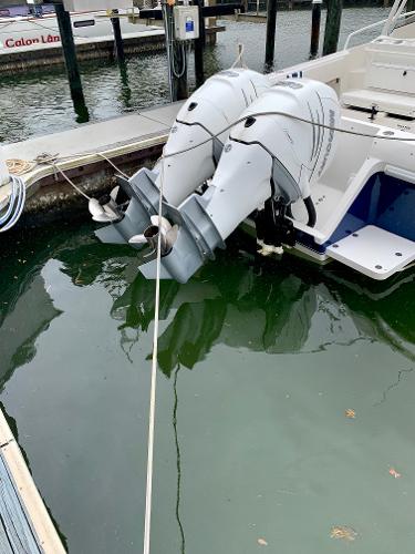 Slide: The Image of 2002 Intrepid 348 Walkaround with twin outboard motors docked in marina. - 7