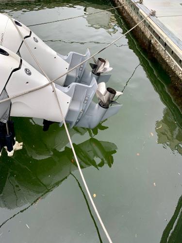 Slide: The Image of Outboard motors of a 2002 Intrepid 348 Walkaround boat docked in water. - 8