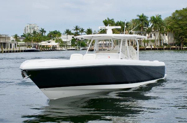Slide: The Image of 2023 Intrepid 475 Panacea boat cruising on a calm waterway. - 0