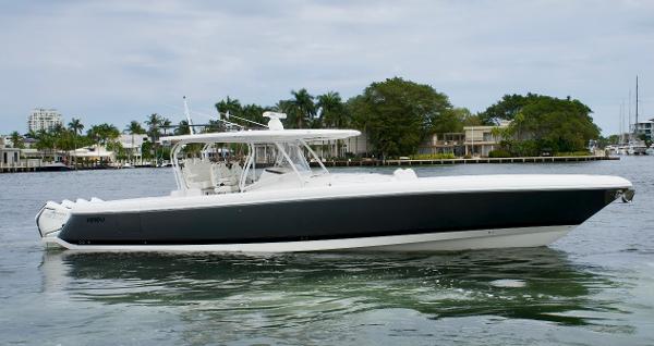 Slide: The Image of 2023 Intrepid 475 Panacea boat cruising on a calm waterway. - 1