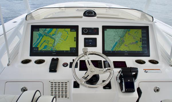 Slide: The Image of 2023 Intrepid 475 Panacea helm with dual navigation screens and modern controls. - 12