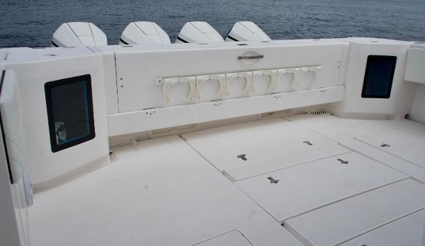 Slide: The Image of 2023 Intrepid 475 Panacea boat deck with rod holders and storage compartments. - 16