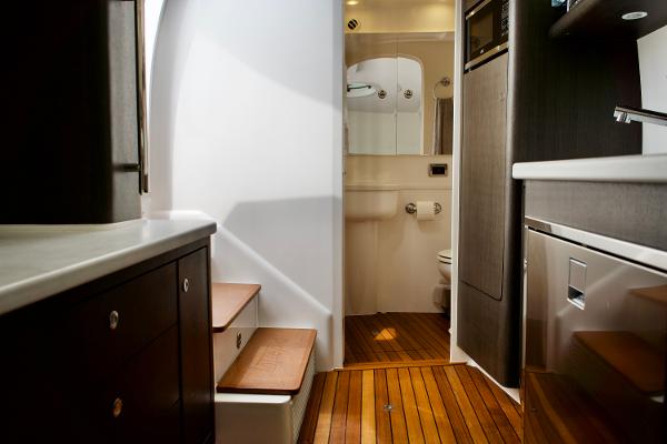 Slide: The Image of Interior of 2023 Intrepid 475 Panacea yacht with wooden flooring and modern amenities. - 18